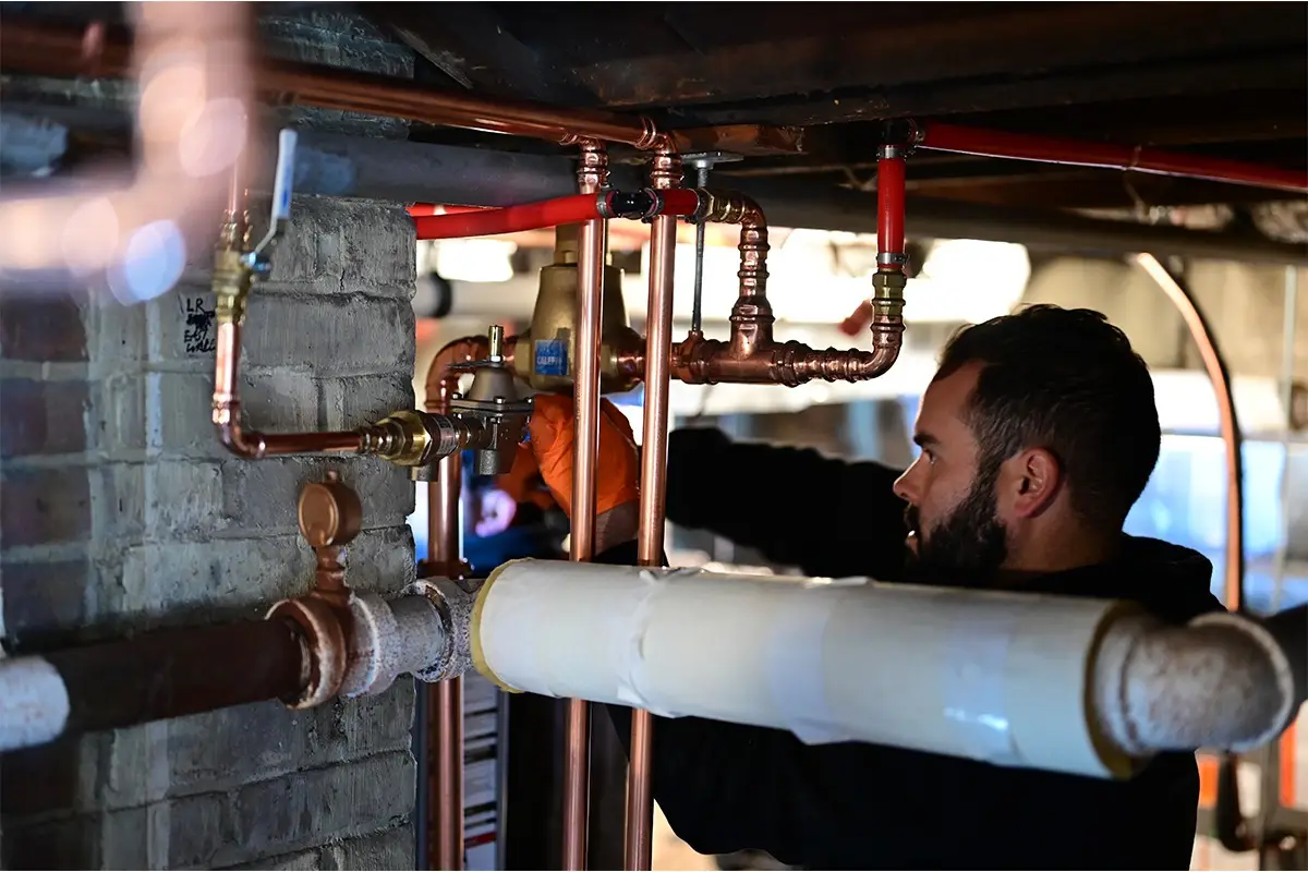 Alex installing a new water line for a water heater install